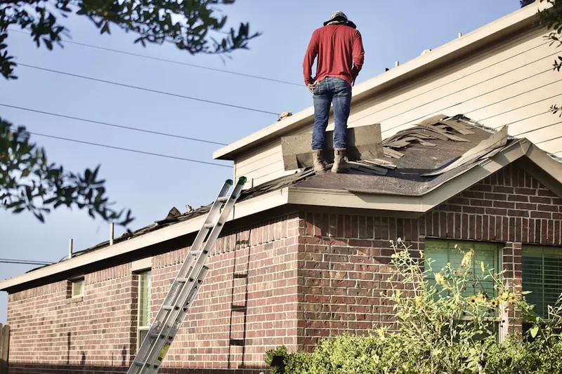 Professional roofer working on a residential roof in Rockford Riverview Estates